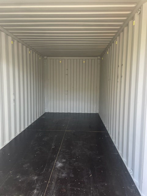Interior of a 20 ft standard One-Trip container, clean white corrugated steel walls, looking toward front wall