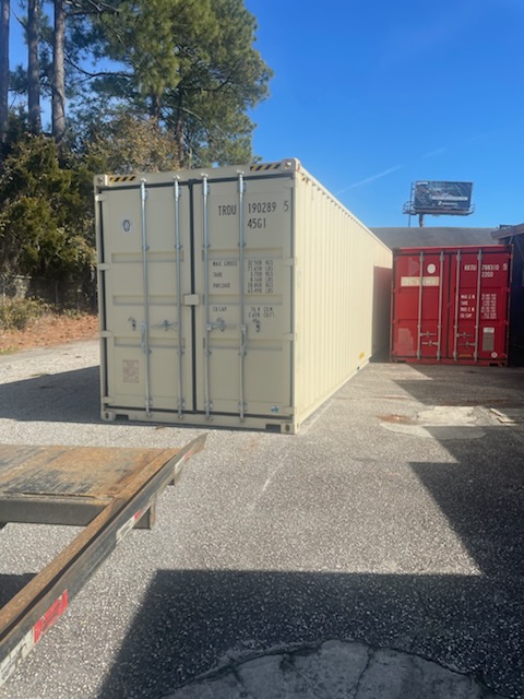 40 ft High-Cube One-Trip container, cream factory paint, side and door end visible, unit ID TRDU190289 and ISO code 45G1, depot yard
