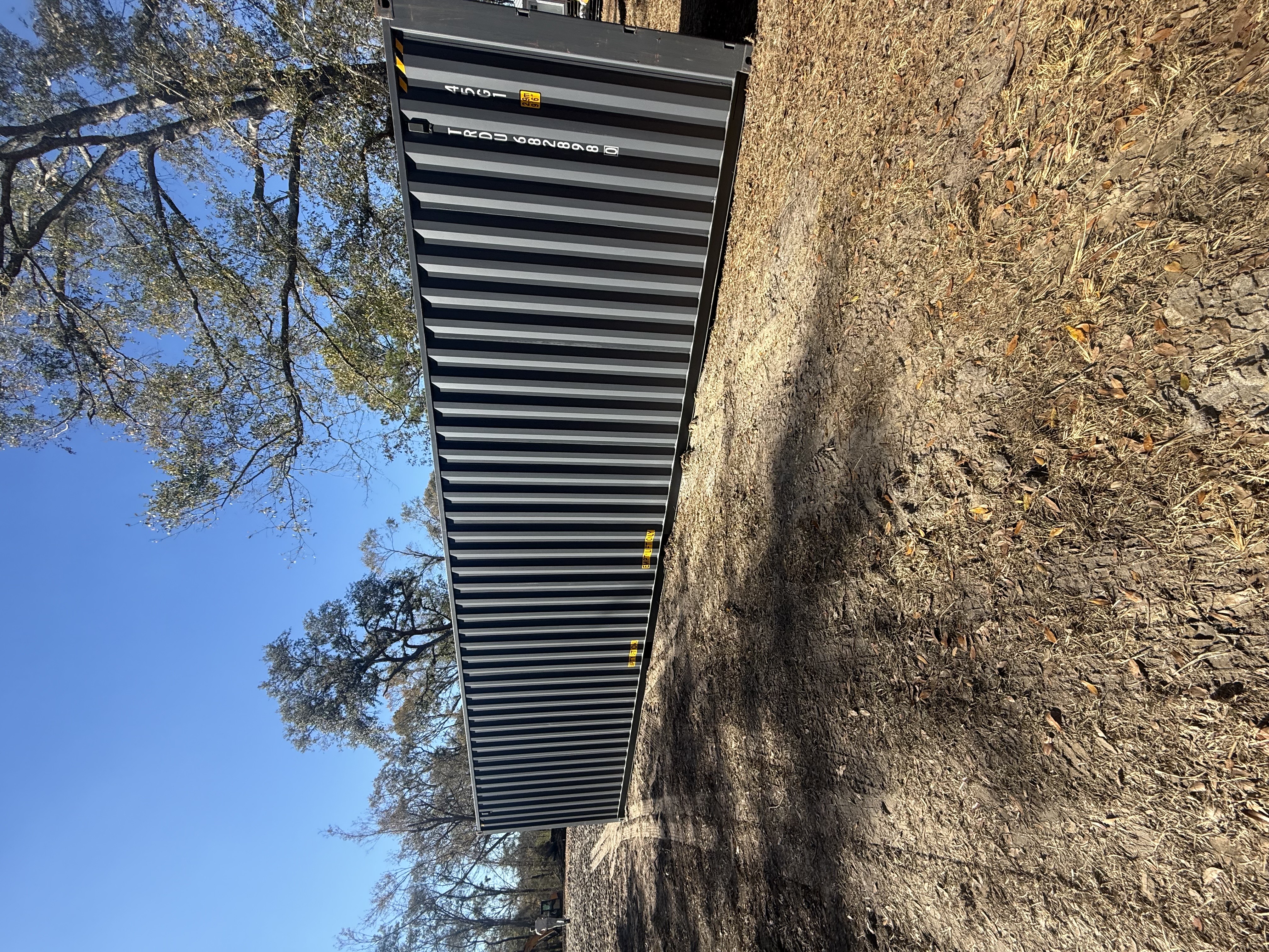 40 ft High-Cube One-Trip container, matte black paint, side profile showing full 40 ft length, unit ID TRDU668289