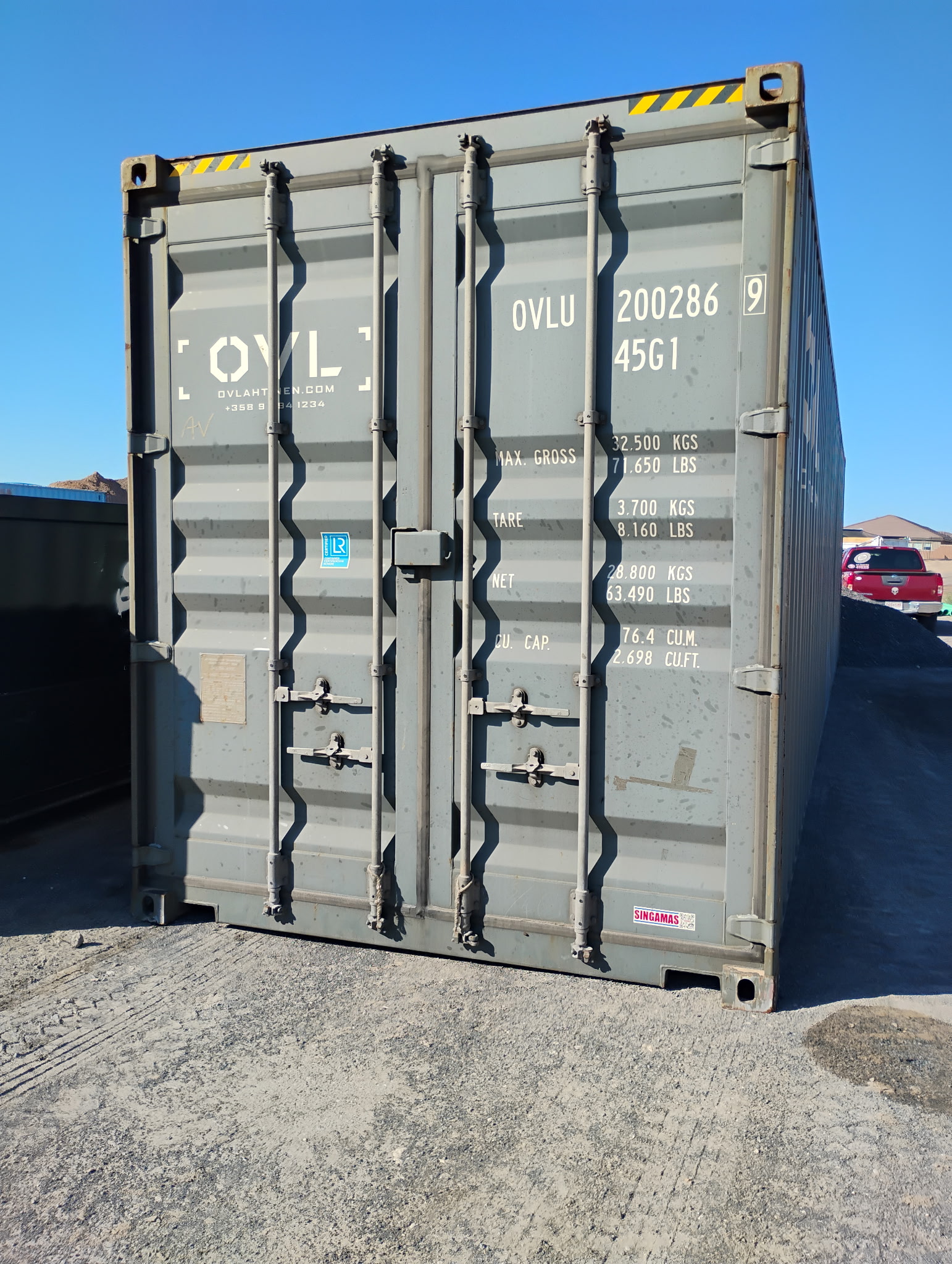 Grey 40 ft High-Cube Premium Multi-Trip shipping container, door end with intact locking rods and limited visible wear