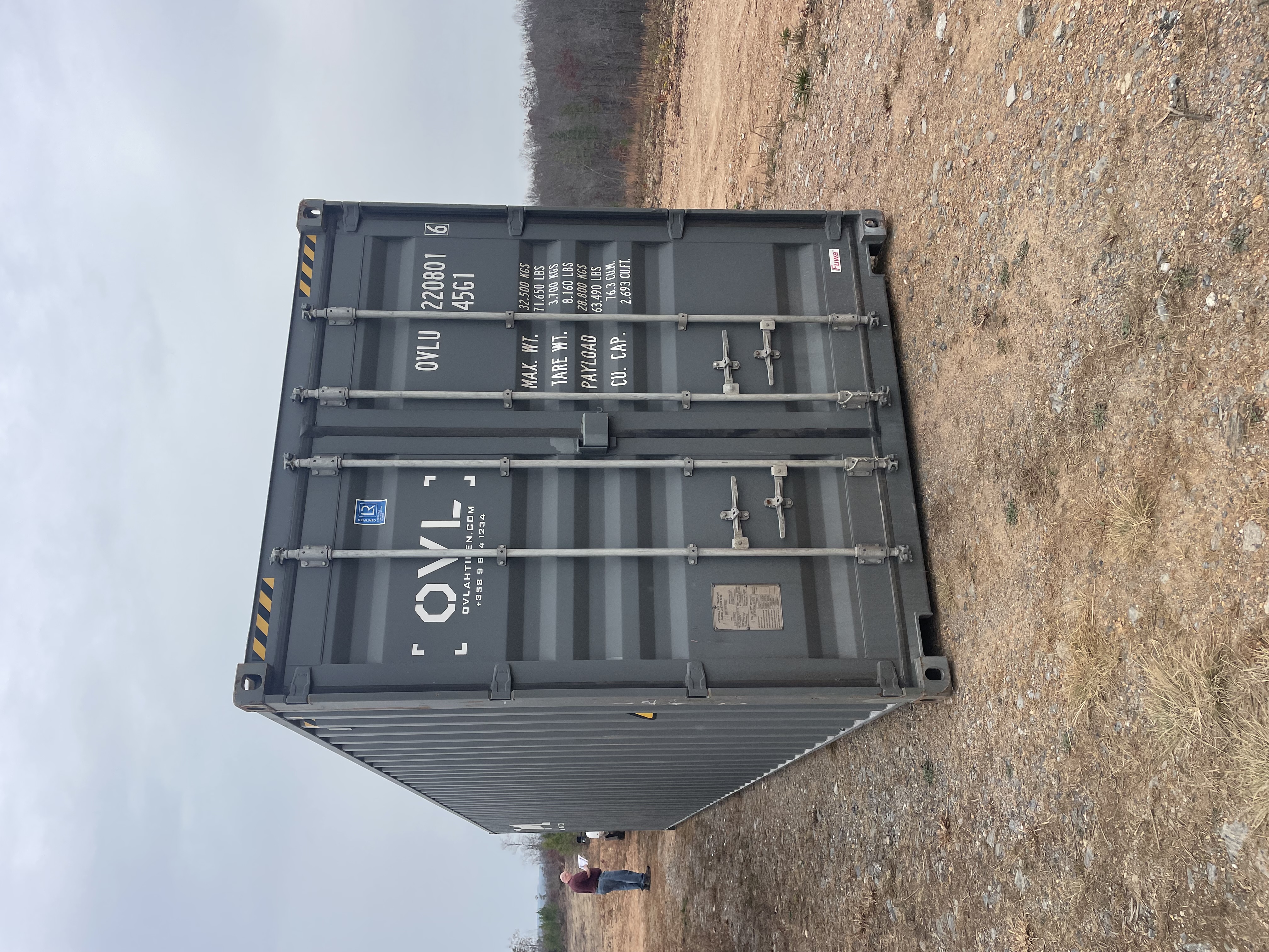 A shipping container delivered at a prepared site