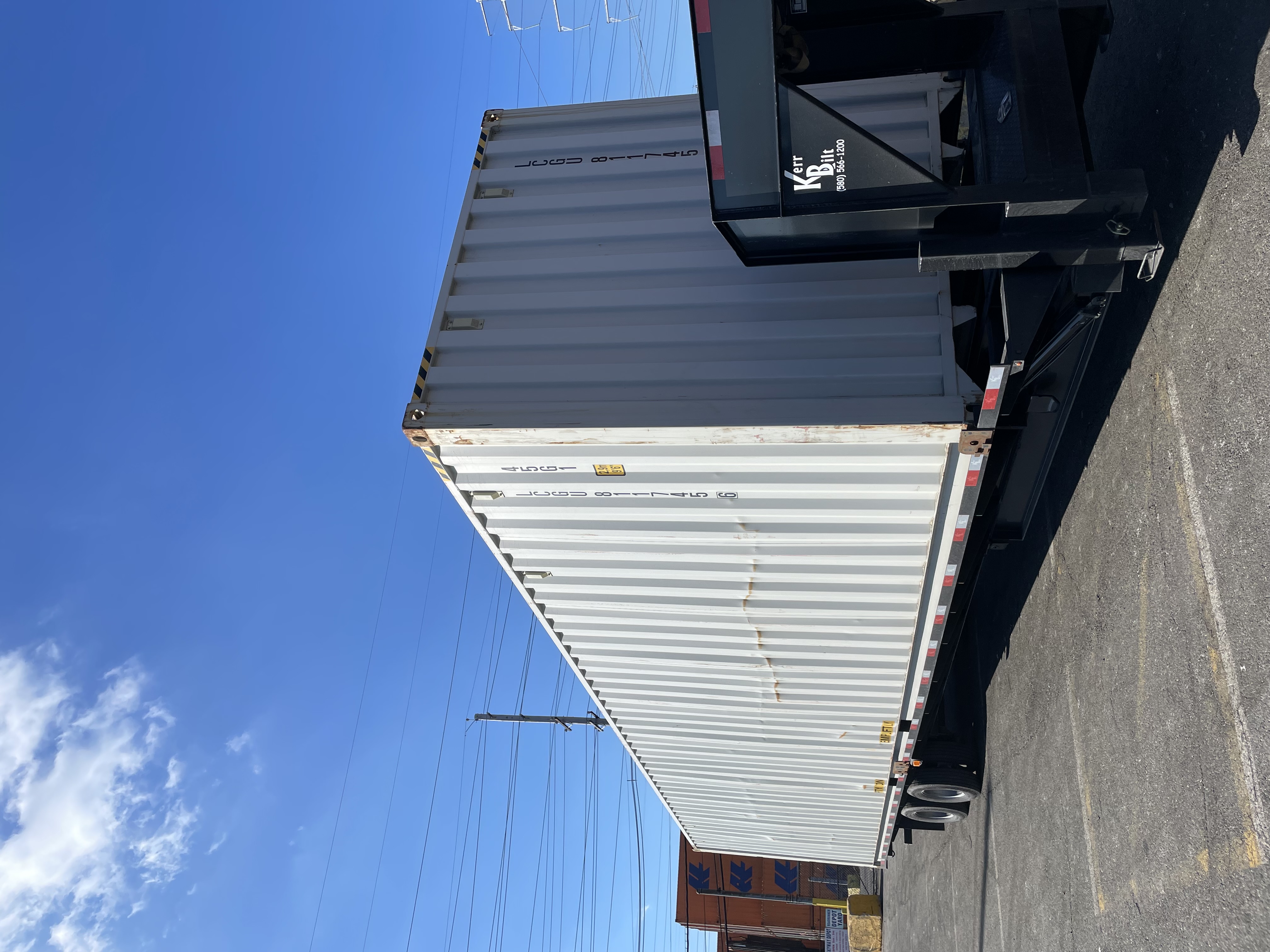 White 40 ft High-Cube Premium Multi-Trip shipping container on a trailer, viewed from the rear corner